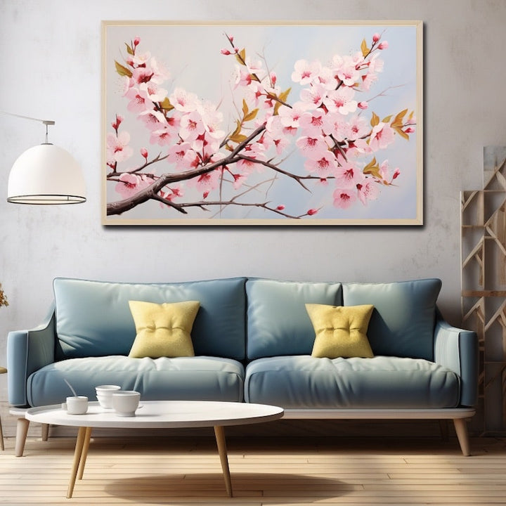 Tableau d'une branche de cerisier japonais en fleurs, pétales roses et feuilles dorées sur ciel bleu pâle